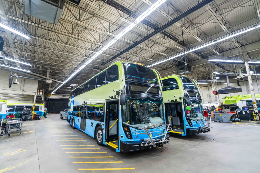 Two STA double decker buses parked in a maintenance garage.