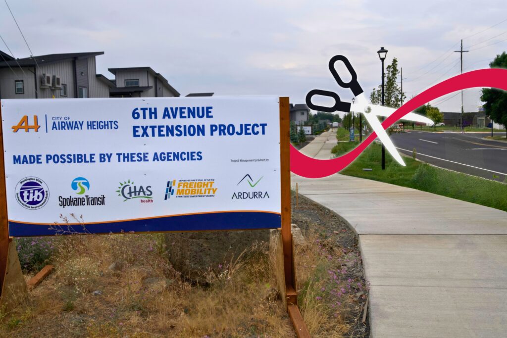 6th Avenue Extension Project sign by a road with digitally added scissors and ribbon.