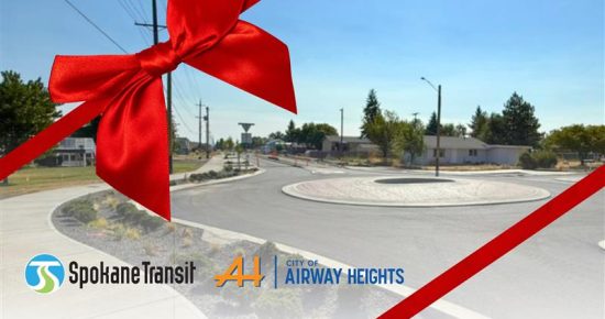 Roundabout with large red ribbon; Spokane Transit and Airway Heights logos in front.